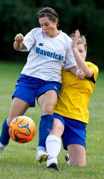 BATTLE FOR THE BALL &#8211; Kristen Patrick of Mavericks 09 tries to maintain possession against a sliding tackle from Suzanne Douziech of the Morinville Ladies in the St.