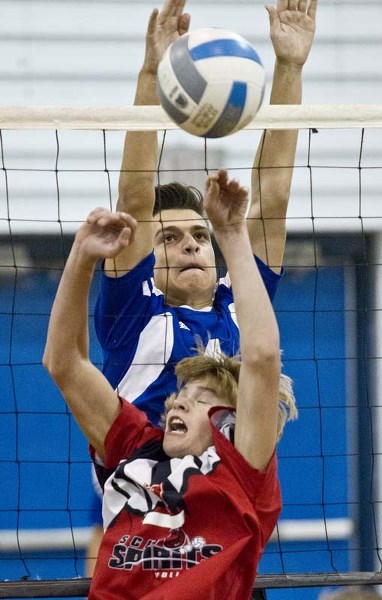VOLLEYBALL SWINGS INTO ACTION &#8211; Marko Ogar of the Paul Kane Blues guards the net against Evan Majeau of the Sturgeon Spirits at the 11th annual Ryan Burak Invitational