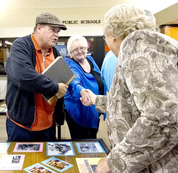 NAMESAKES – Former public school board trustee Joan Trettler (right) shakes hands with Leo Nickerson teacher Chris Akins and his aunt