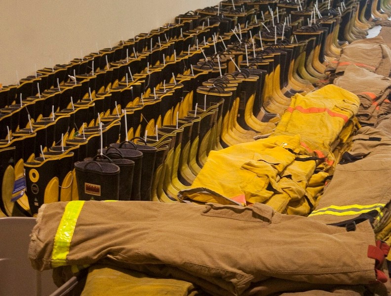 Donated fire equipment sits in a warehouse ready for distribution.