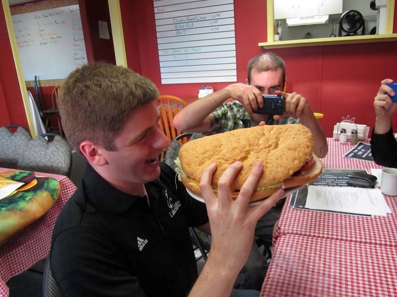 NICE TRY – A member of the Morinville Festival Society attempts to eat the Morinville Monster ahead of Saturday&#8217;s competition.