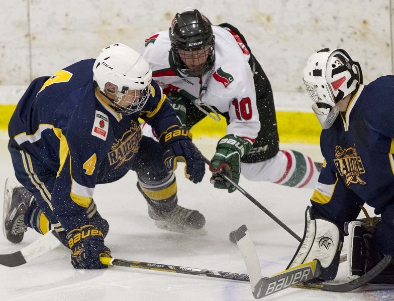 ATTACKING THE NET – James Hamblin (10) of the Southside Athletic Club battles Kole Bryks of the St. Albert Raiders for the puck beside the net guarded by Joshua Dechaine in