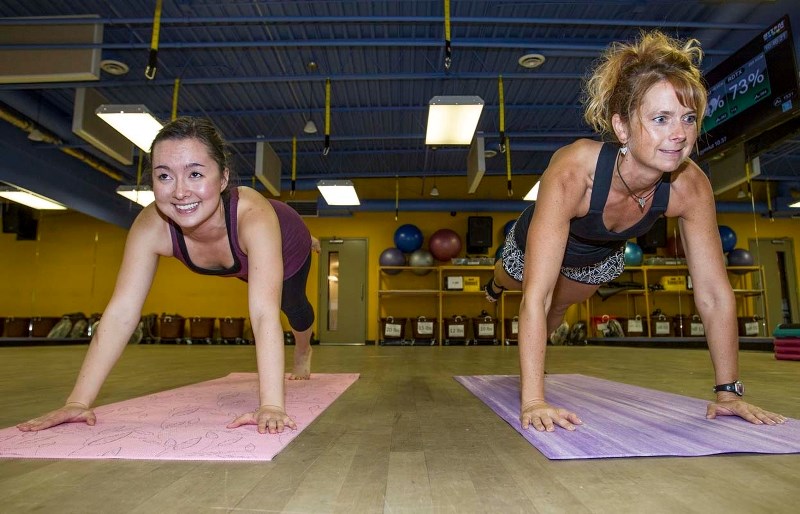 PIYO IT &#8211; Gazette reporter Amy Crofts (left) and fitness instructor Keri Bowzaylo balance in one leg high planks as a part of a series of PiYo exercises in the hybrid