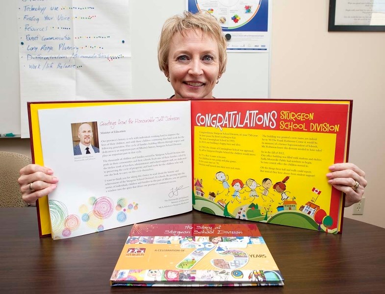 ANNIVERSARY BOOK – Curriculum and instruction director Ruth Kuik shows off the special history book created by Sturgeon School Division students in celebration of the