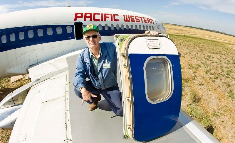 MISSING – An Alberta Aviation Museum volunteer holds an emergency door like the one taken.