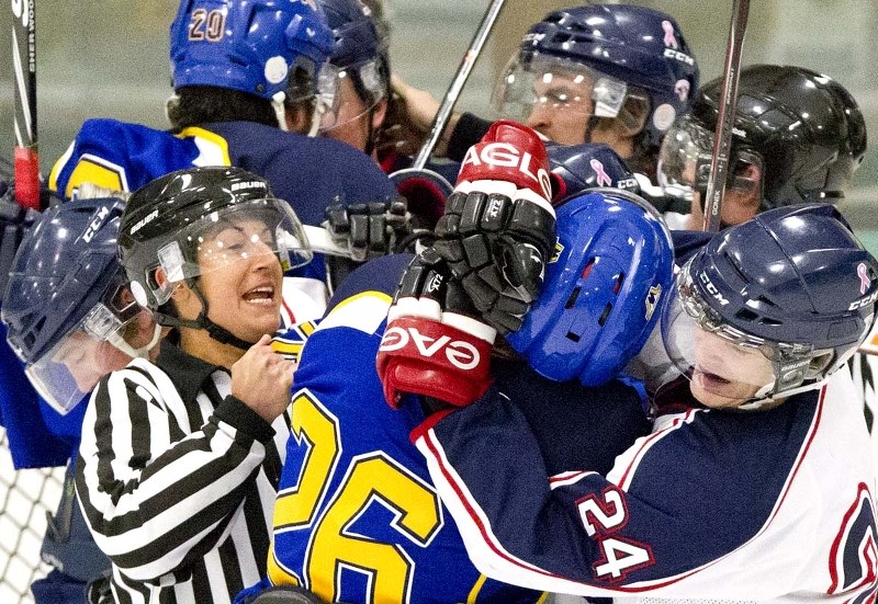 PEACEMAKER &#8211; Lacey Senuk of the St. Albert Referees Association attempts to break up a scrum between the St. Albert Merchants and Spruce Grove Regals in Sunday&#8217;s