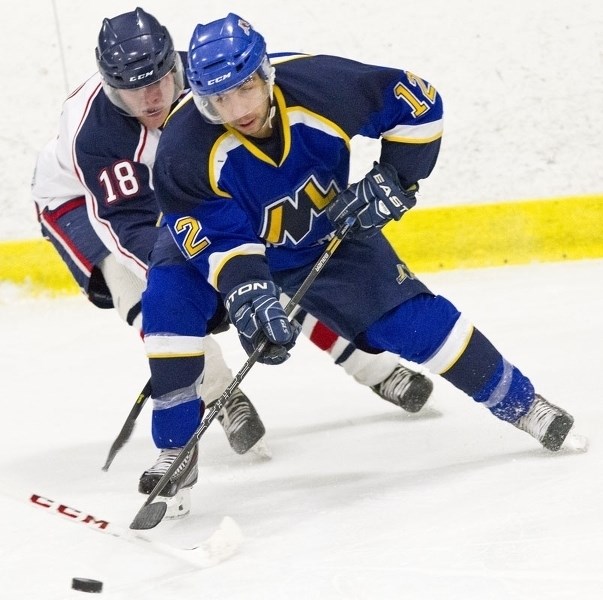 FOLLOW THE LEADER &#8211; Thomas Rotundo of the St. Albert Merchants is pressured by Harrison Blayney of the Spruce Grove Regals in junior B action last weekend in St.