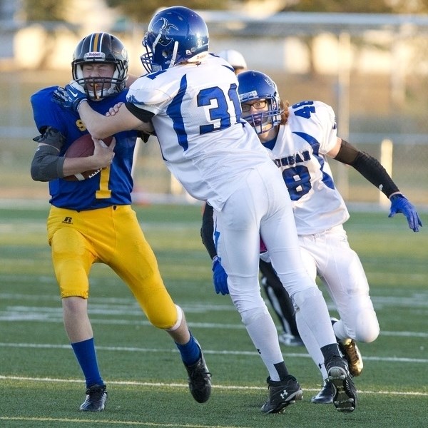 COLLARED &#8211; St. Albert High Skyhawks quarterback Sam Cuciz is on the receiving end of a high tackle by Logan Leblanc of the Ardrossan Bisons in last week&#8217;s Miles