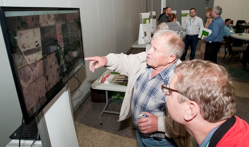 PIPELINE ROUTE – Morinville-area farmer John Hesse (left) points out how the proposed Northern Gateway pipeline will cross his property to Enbridge spokesperson Ray Doering