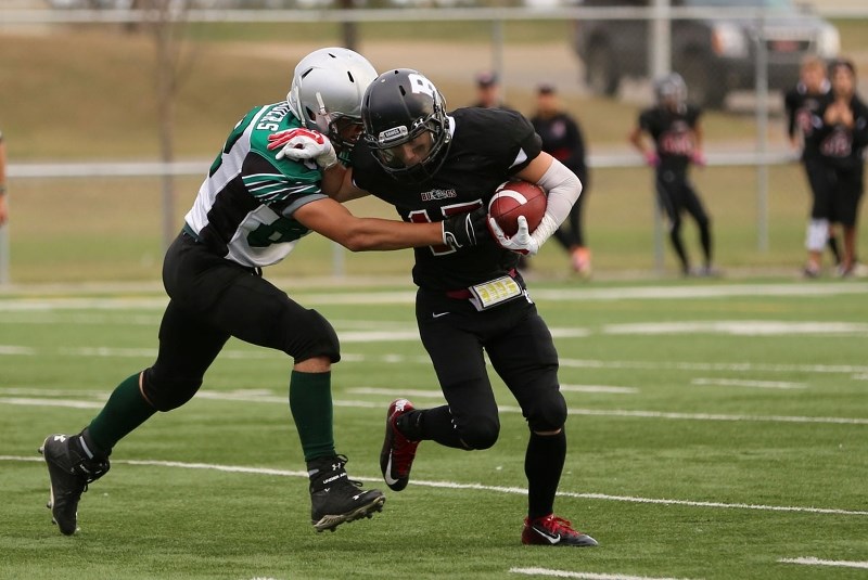 CAUGHT WITH THE BALL – Kit Liske of the Bellerose Bulldogs is tracked down by the Austin O&#8217;Brien Crusaders in last month&#8217;s Carr division one game at Riel