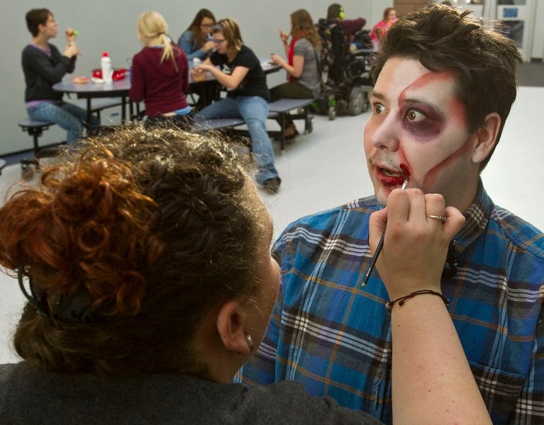 Youth outreach worker for the Town of Morinville Brian Croft gets a zombie make-over at Morinville Community High School during a makeup demo to promote the upcoming zombie