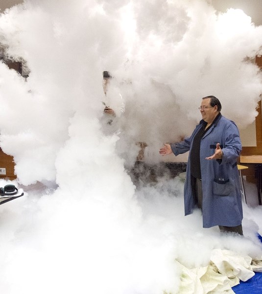 I SUMMON THEE! ‚Äi MacEwean University professor Lucio Gelmini appears to summon Paul Kane chemistry teacher Michael Ng in a cloud of smoke. The two teachers were performing