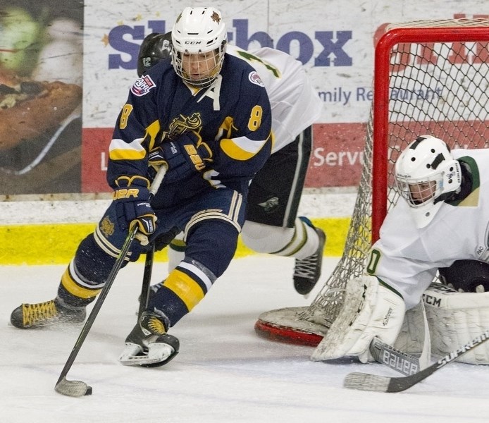 ATTACKING THE NET – Leif Mattson of the midget 15 St. Albert Flyers controls the puck as Brandon Ewanchyshyn guards the net for the Spruce Grove PAC Saints in Sunday&#8217;s