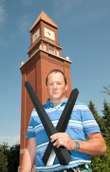 TIME FOR A CHANGE – City of St. Albert asset manager supervisor Doug Moore holds a pair of replacement hands for the clock tower on Perron Street in this July 2014 photo.
