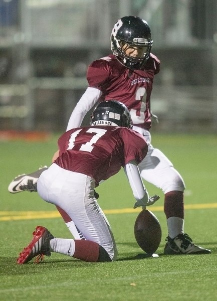 KICK TO WIN – Alex Lesko holds the ball for Jaedon Carroll to convert one of the eight touchdowns by the Bellerose Bulldogs in Wednesday&#8217;s 62-14 rout of the Bev Facey