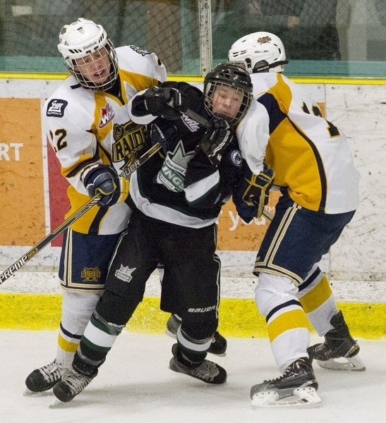 CAUGHT IN THE MIDDLE &#8211; A Sherwood Park Flyer is sandwiched by a pair of St. Albert Sabres in Sunday&#8217;s bantam AAA game at Akinsdale Arena. Garrett Clegg and Mason
