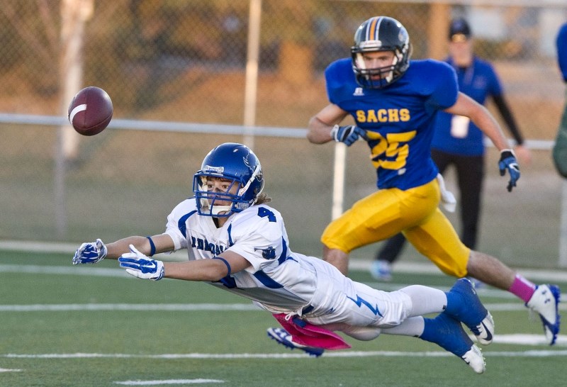 UP FOR GRABS &#8211; Riley Laplante of the Ardrossan Bisons attempts a diving catch in front of Kris Akkerman of the St. Albert High Skyhawks during a Miles division two game 