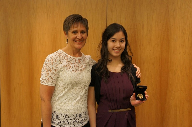 Teacher Nancy Watts hugs piano student Justine Lai after the emerging star was awarded The Royal Conservatory of Music gold medal for piano performance.