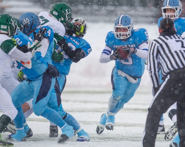 POWER PLAY – Kieran Porter of the Paul Kane Blues charges towards a hole to power through against the St. Joseph&#8217;s Celtics of Grande Prairie in the Tier II north