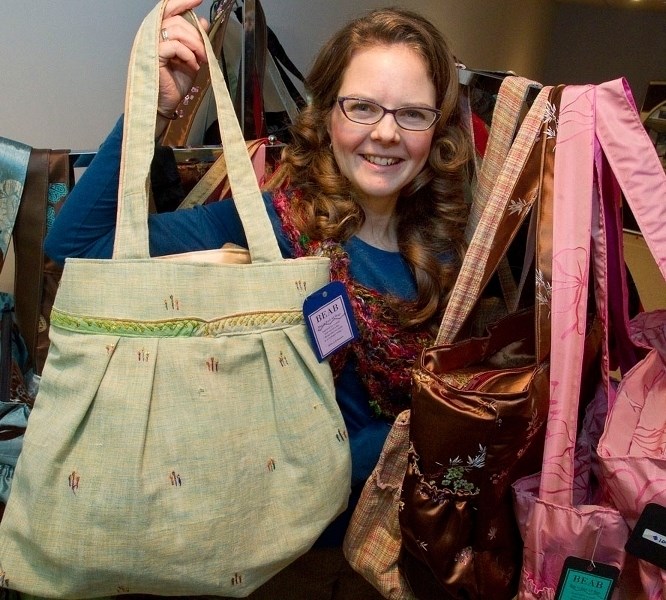 CALLING – Amy Roy Gratton holds some of her handmade bags.