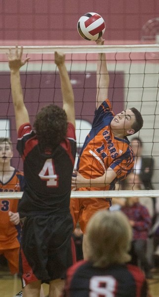 HIT TO WIN &#8211; Davis Pratt of the Lorne Akins Gators strikes the ball as Eric Rolheiser of the Sir George Simpson Voyageurs throws up a block in the SAPEC Tier 1 city