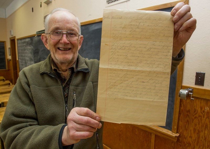 OLD SCHOOL – County resident John Bocock shows off a writing assignment he did in the 1940s while attending the one-room school at Volmer. In it