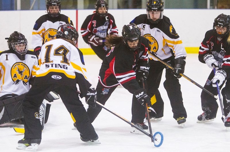 MISSION CONTROL – Leah McIntosh of the St. Albert U14 AA Mission team battles for the ring