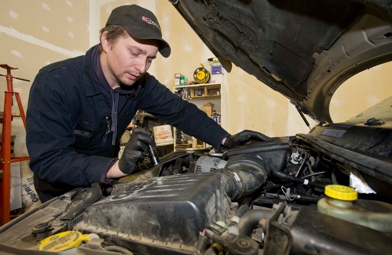 St. Albert Auto Care technician Matthew Lee performs a vehicle inspection at his shop recently. Mechanics can verify if a vehicle is road worthy perfor a customer buys it
