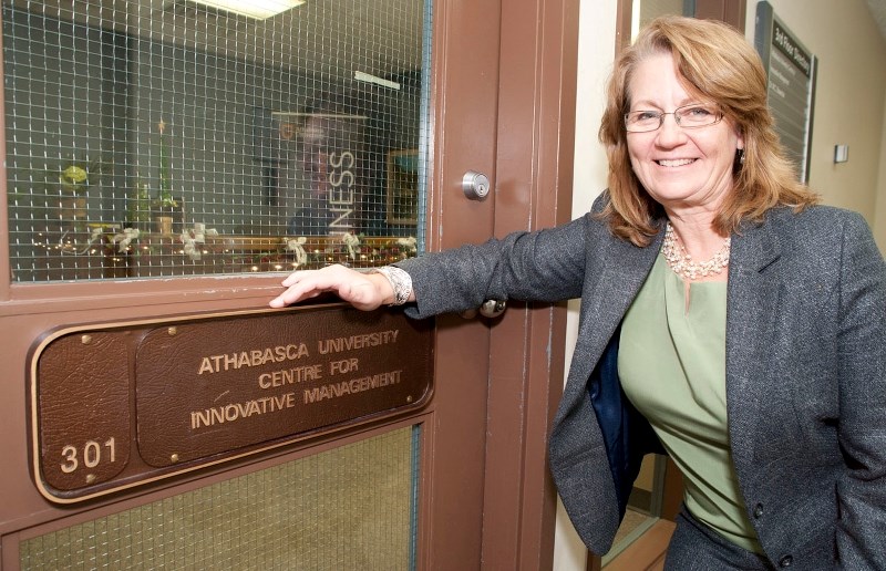 LEAVING TOWN – Athabasca University Dean of Business Deborah Hurst stands by the door to her university&#8217;s St. Albert office in the Grandin mall office tower