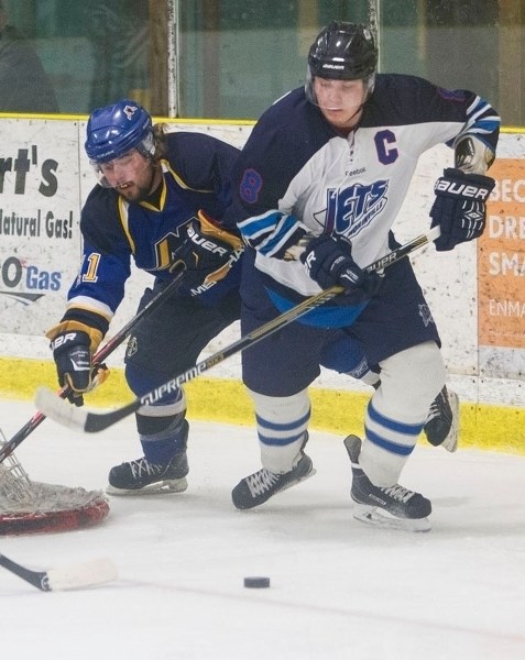 JUNIOR B RIVALS – Morinville Jets captain Jorden Rooke skates after the puck against A.J. Yariwon of the St. Albert Merchants in last month&#8217;s junior B game in St.