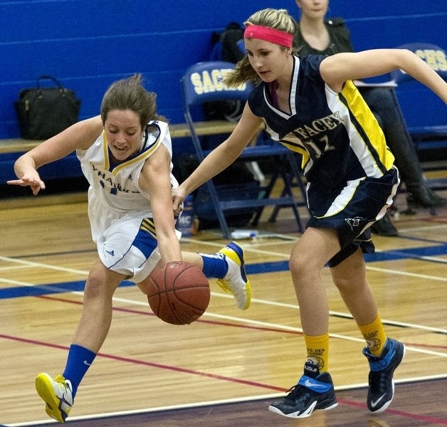 RUNNING THE FLOOR – Sam Dargis of the St. Albert Skyhawks races past Dayna Bullock of the Bev Facey Falcons in Wednesday&#8217;s metro Edmonton division one game at the