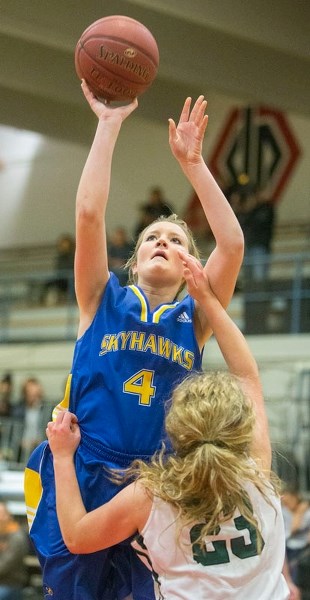 SHOOTING FOR SUCCESS – Jamie Bain of the St. Albert Skyhawks shoots for the hoop in front of Sofia Larmour of the Holy Cross Crusaders of Saskatoon in Saturday&#8217;s final