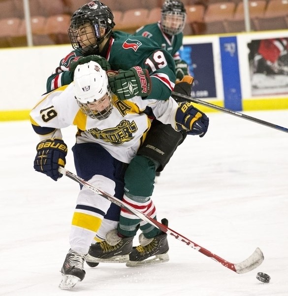INTERFERENCE – Assistant captain Mattias Neset of the St. Albert Crusaders is wrapped up by Nickolas Bishop of SSAC Don Wheaton in Northern Alberta Midget AA Hockey League