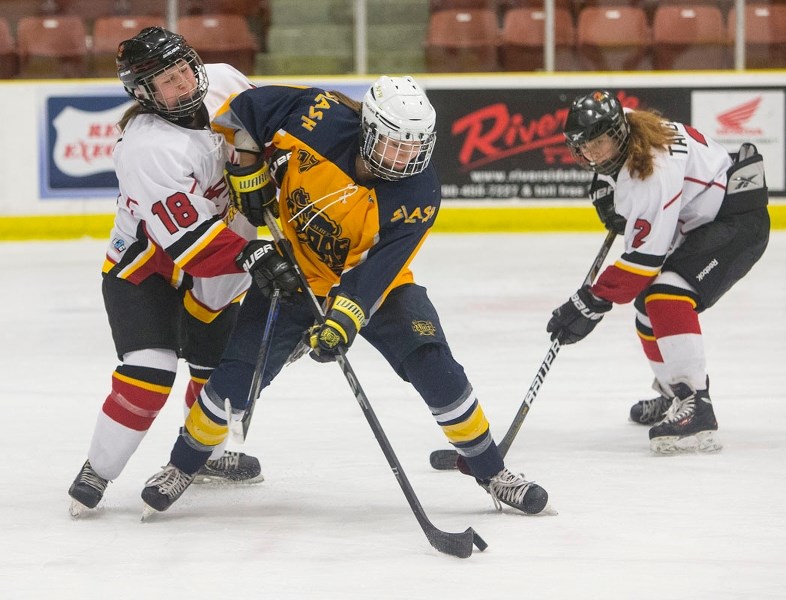 POSSESSION PLAY – Megan Lalor of the St. Albert Slash controls the puck while fending off Robyn Scholz of the Calgary Fire in a recent Alberta Major Midget Female Hockey