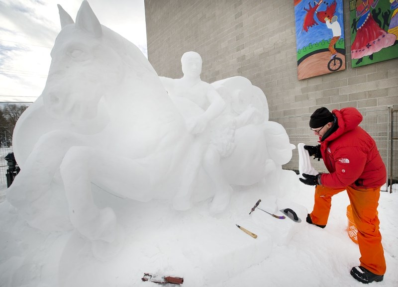 Scandinavian snow sculptor Wilfred Steijger works on one of the ice sculptures that will be part of the eighth annual Deep Freeze Byzantine Winter Festival