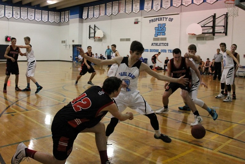 TOURNAMENT HOOPS – Zane MacDonald of the Sturgeon Spirits is guarded by Graeme Scheffer of the Paul Kane Blues while making a bounce pass to Corbin McCormack