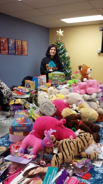 Sophia Qaderi preparing gifts of donated toys and games before they were delivered to the Stollery Children&#8217;s Hospital and St. Albert Victim Services in December.
