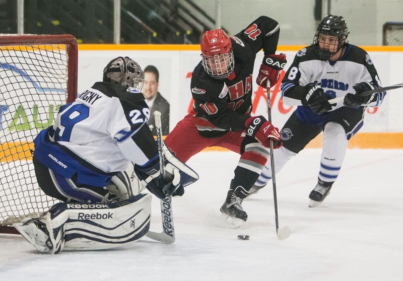 BUSTING A MOVE – Keltie Jeri-Leon of the Okanagan Hockey Academy of Penticton opened the scoring on this play in the first period against netminder J.P. Tourigny of the