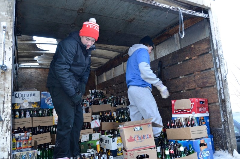 SACHS Interact club members Liam McRae and Kristofer Akkerman help load up a five-ton cube truck with the collection from a recent bottle drive. The club raised a whopping $1