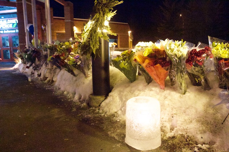 The collection of flowers continues to grow at the RCMP detachment in St. Albert. Seen here on Monday night following the press conference in the evening.