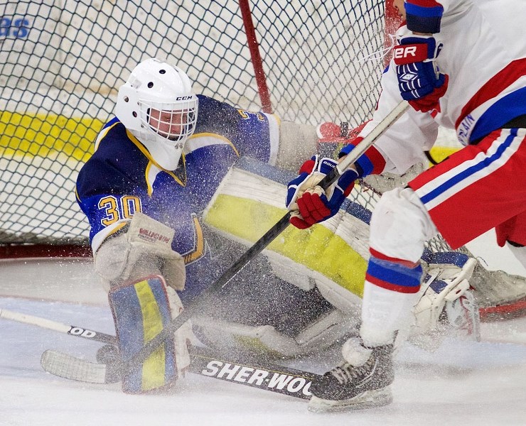 CARETAKER OF THE CORD COTTAGE – Ty Clelland of the St. Albert Merchants guards the net against Joey Berget of the Stony Plain Flyers in Sunday&#8217;s junior B game at