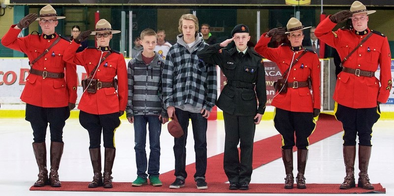 STANDING AT ATTENTION – RCMP members join the three sons of fallen Const. David Wynn – Alex