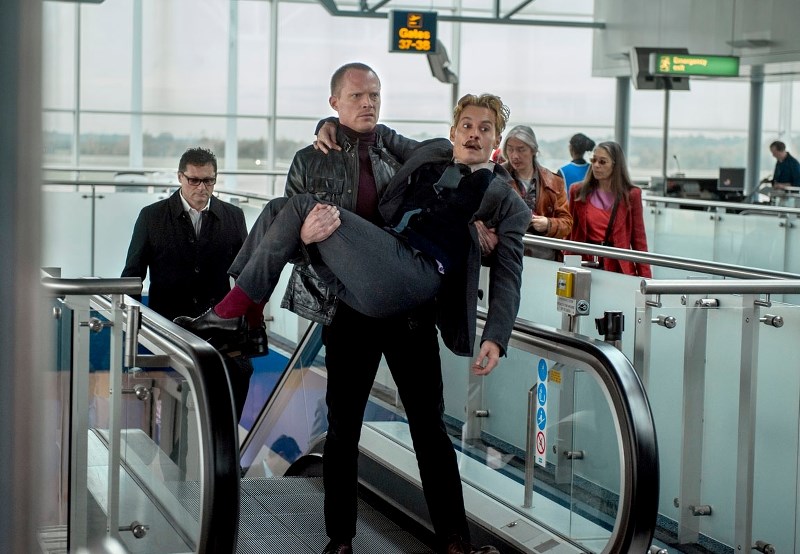 Jock (Paul Bettany) carries an effete Charlie Mortdecai (Johnny Depp)