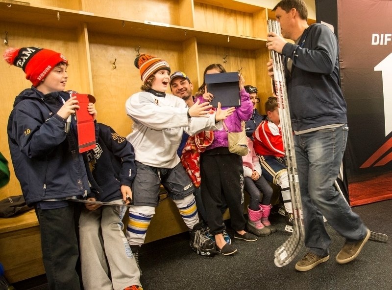SPECIAL STICKS – An excited Matteo Gallo of the atom AA St. Albert Lightning reacts to the arrival of the new Bauer 1X hockey sticks from the Bauer rep during a surprise