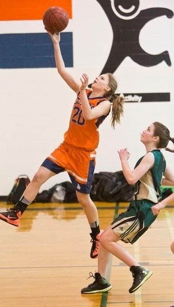 LEAPING BASKET &#8211; Kaitlyn Kluttig of the Lorne Akins Gators goes for a layup in front of Willow Townsend of the William D. Cuts Crusaders in Tuesday&#8217;s SAPEC junior 