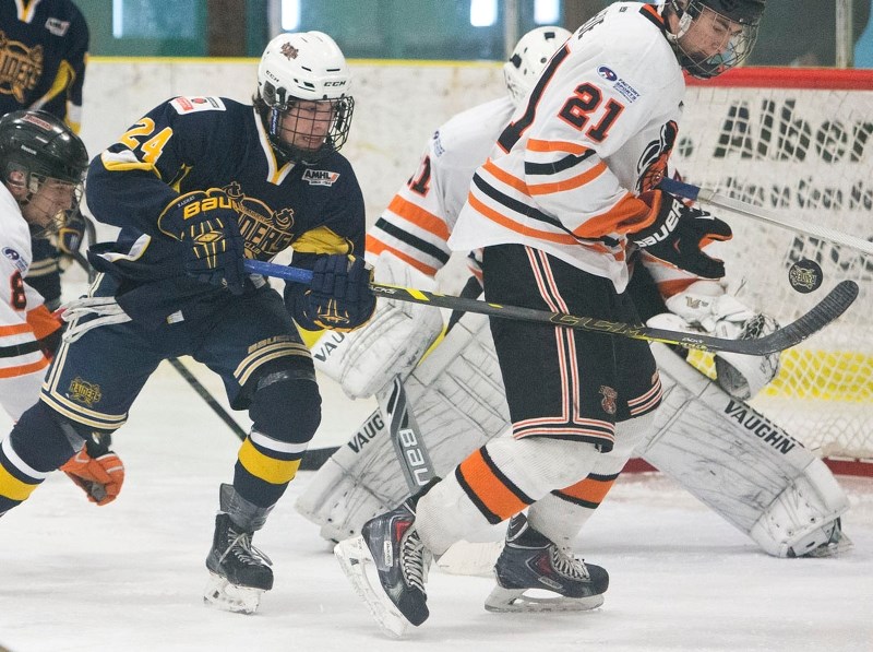 BATTER UP -– Brayden Nicholetts of the St. Albert Raiders plays the puck in the air in front of Jantzen Leslie of the Lloydminster Bobcats in Sunday&#8217;s midget AAA game