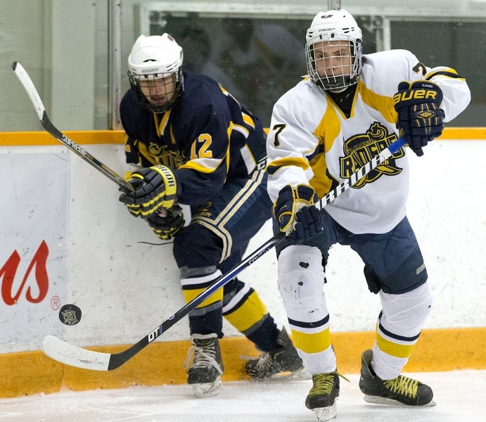 MIDGET AA SHOWDOWN – Logan McKay of the St. Albert Crusaders plays the puck in front of Nathan Durocher of the St. Albert Blues in Tuesday&#8217;s game in the Northern