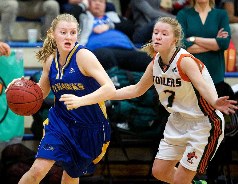 BUSTING A MOVE – Alexi Pusch of the St. Albert Skyhawks pushes the ball against Shannon Patoine of the Peacock Tornadoes of Moose Jaw in the Titans Tri-Prov final Saturday at 