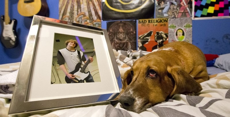 Caelin Porter&#8217;s dog Roo lays beside a photo of Porter who committed suicide in December.