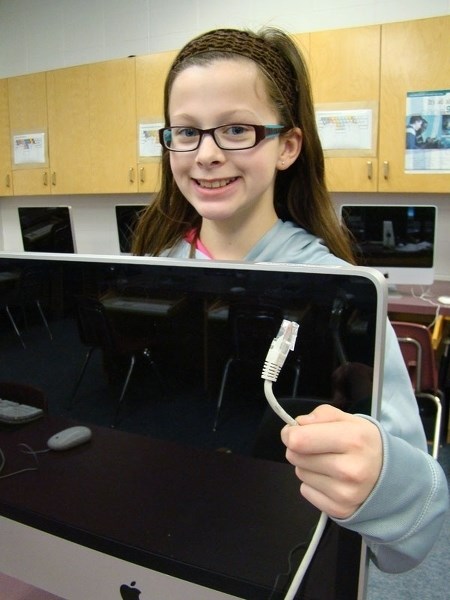 école Marie Poburan student Lauren Sutcliffe unplugs her computer as a way of giving up technology for Lent.